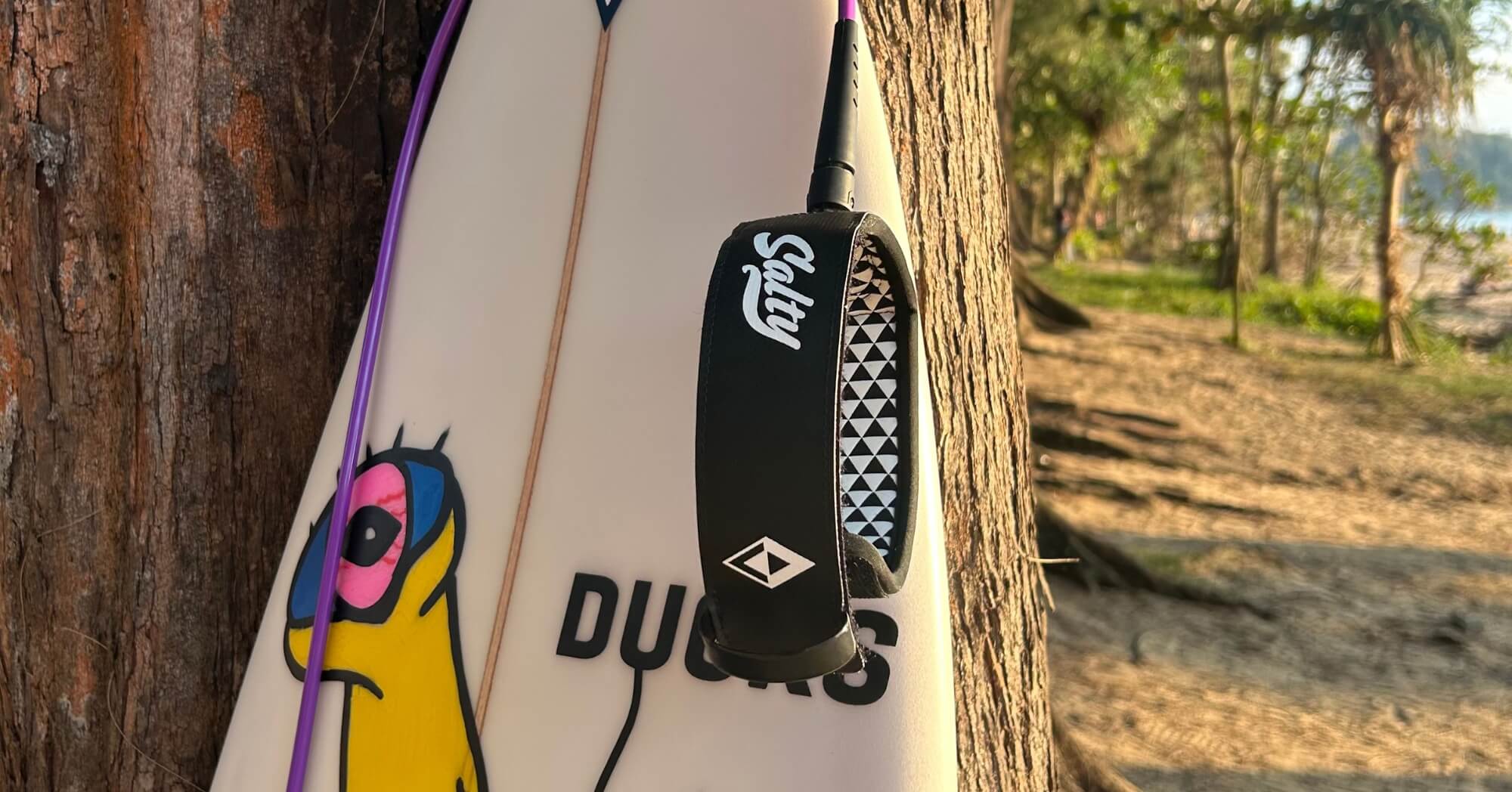 Salty surfboard leash hanging on board – best-selling surf gear banner